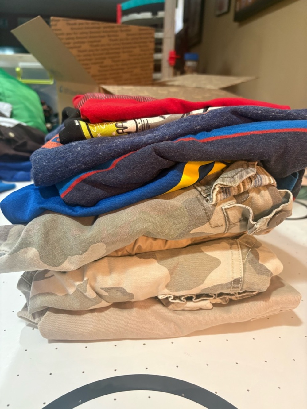 Stack of Casual Boys' Clothing - Camouflage Shorts & Colored Tees